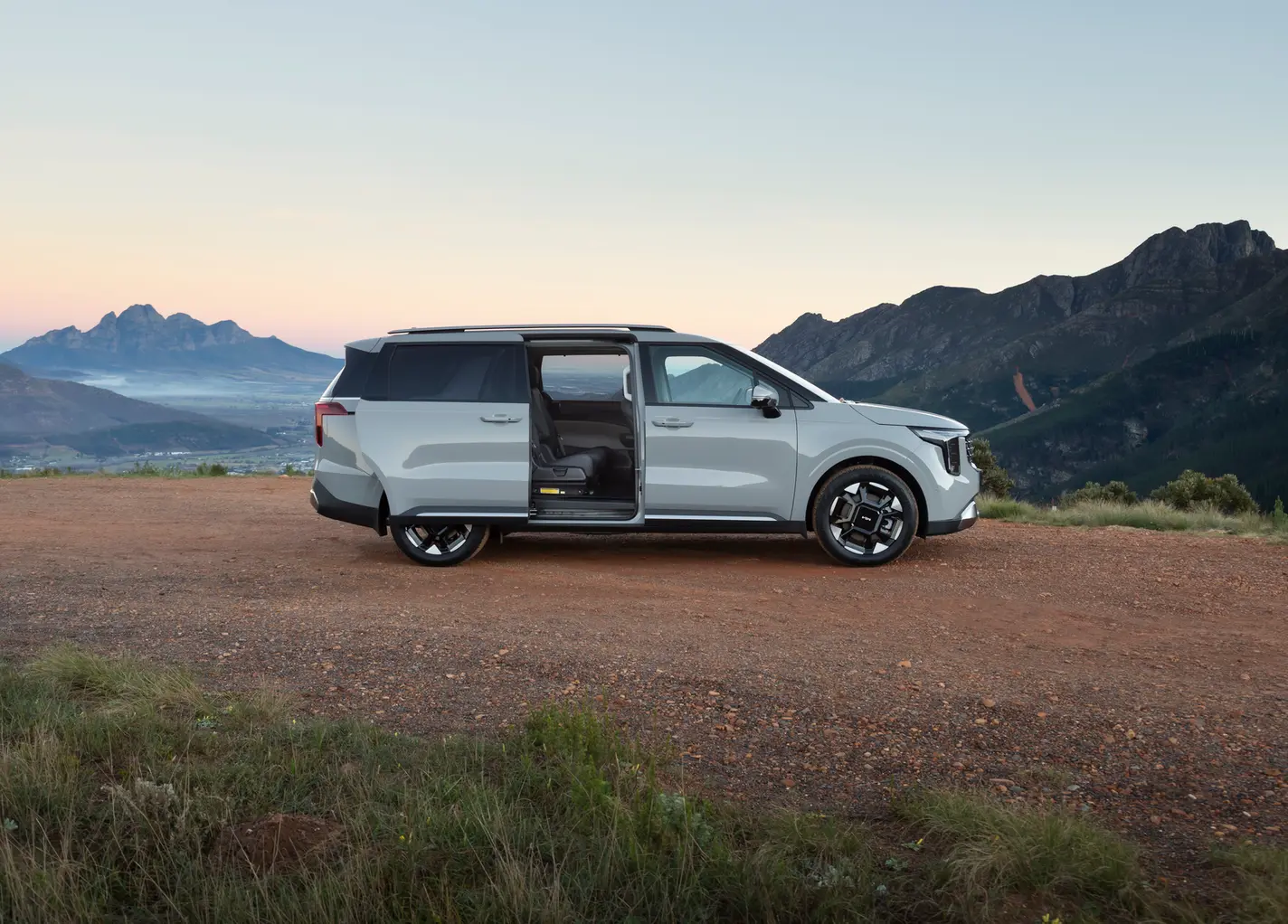 Silver Kia Carnival open door on Cape Town mountain road